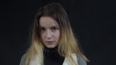 Teenager girl showing stupid gesture. You are stupid!