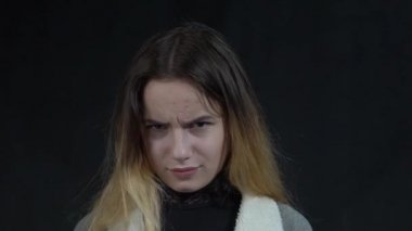 Slow Motion Attractive woman rolling index finger near temple, showing shock 