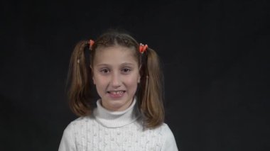 Slow Motion Lifestyle portrait of a child girl smiling at camera, youth day.