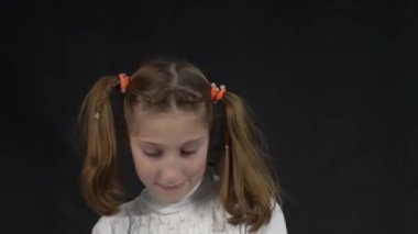 Girl looking shy and cute, blushing, looking from under forehead