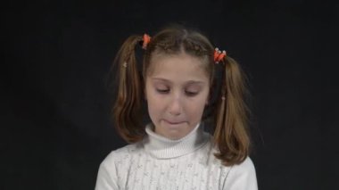 Slow Motion Positive young Caucasian woman has shy expression, blinks eyes