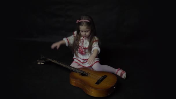 Little Cheerful Girl Playing Guitar Isolated Black — Vídeos de Stock