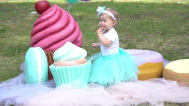 Girl resting in park on background of large lollipops