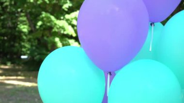 Slow Motion Blue balloons on the green lawn