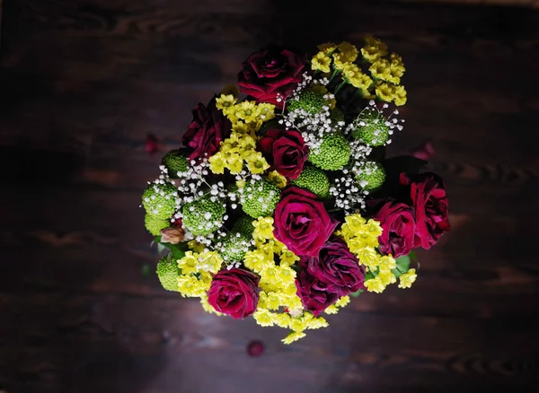 Bouquet of multi-colored flowers. Roses and wild flowers. Bouquet of colorful flowers. View from above.