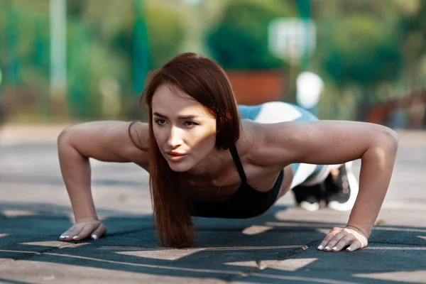 Purposeful Woman Does Push Ups Sports Training Active Lifestyle Thirties — Stockfoto