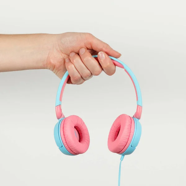 Pink Blue Headphones Hand White Background Music Services Podcasts Streaming — ストック写真