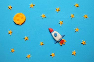 Rocket in space, star, and moon. Plasticine art, cartoon.