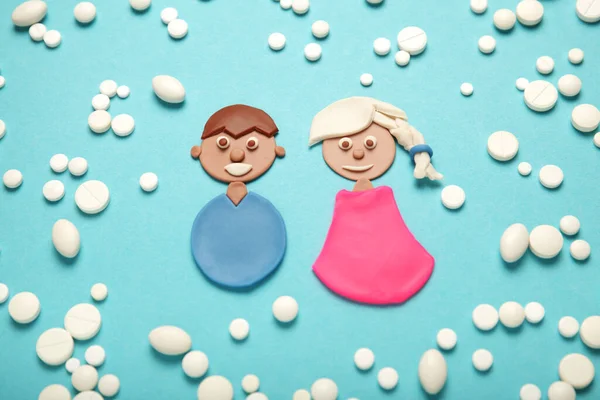 Protection from unwanted pregnancy. Man and woman with medical pills.