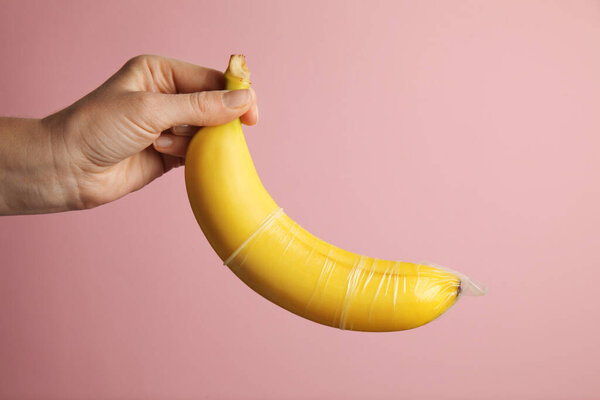 Yellow banana with condom, concept of protected sex.