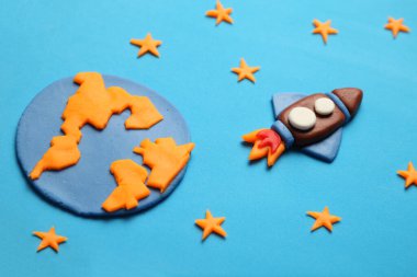 Rocket in space, star, planet earth. Plasticine art, cartoon.