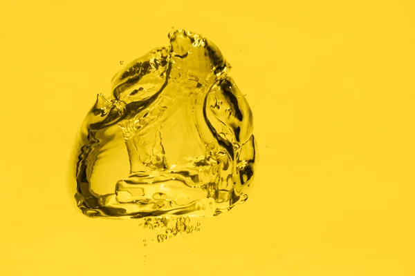 Gold (yellow) oil bubble background. Liquid drops in macro.