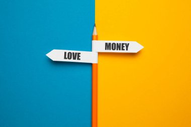 Pencil - direction indicator - choice of love or money. 