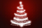 Červené vánoční pozdrav s osvětleným vánoční strom.