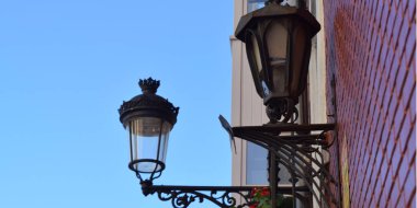 Classic and cast iron lamppost on a building.