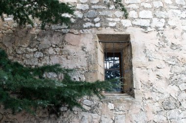 Çam dallı taş pencere.