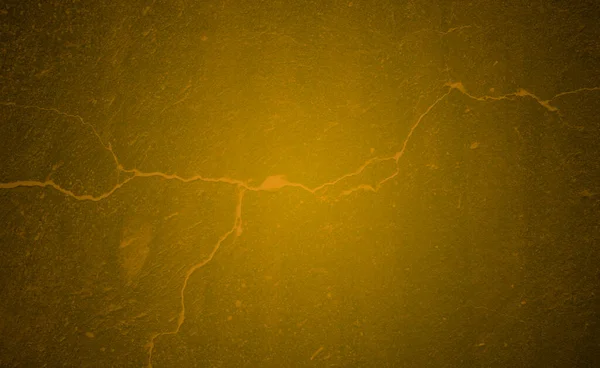 Earth background with cracks in dark mustard radial gradient. Wall or wall with cracks in mustard tone