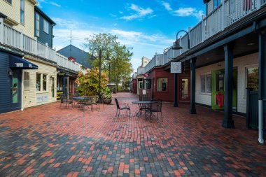 Newport, Rhode Island, USA -- October 22, 2021. A wide angle photo of Newport's Brick Market Place, a shopping area with specialty stores. clipart