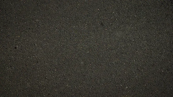暗いアスファルト表面の背景の質感 — ストック写真