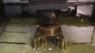Electrical Discharge Machining bath filling with dielectric fluid.