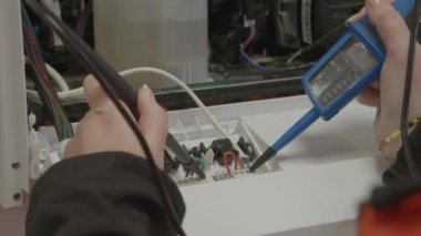 Gaz merkezi ısıtma kazanına hizmet veren kadın mühendis - elektrik denetimi