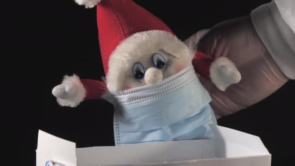 O pequeno gnomo elfo usando uma máscara facial na caixa — Vídeo de Stock
