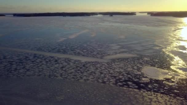 Aerial view of the frozen sea water with the sun rays — Stock Video