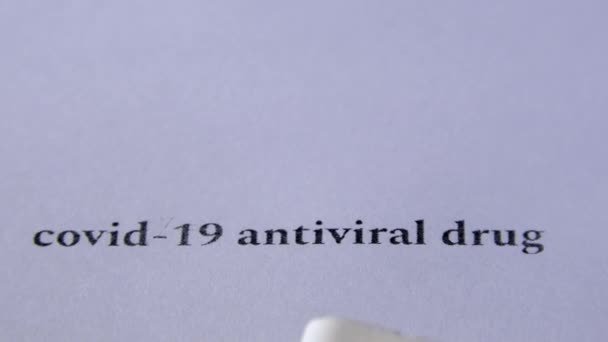 Primer plano de píldoras sobre fondo blanco con texto negro. — Vídeos de Stock