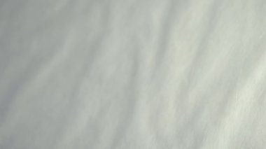 A tray of white eggs being put on the white table