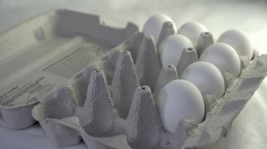 White eggs being pull out from the egg tray
