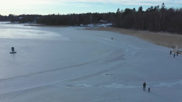 Awesome drone shot of people walking on the frozen sea. — Stock Video