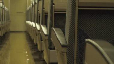 Closeup shot of rows of seats inside an old train wagon.