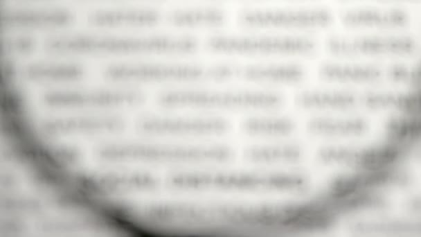 The magnifying glass on top of the news paper.close-up.4K UHD — Stock Video