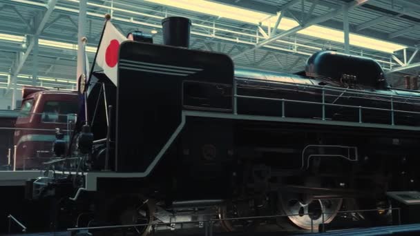 A steam locomotive with a Japanese flag at the Nagoya railway museum. — Stock Video