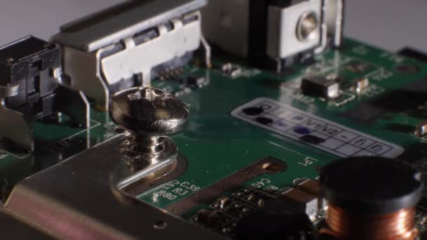 Closeup shot of picking a screw out of a hard drive using fingers. — Stock Video
