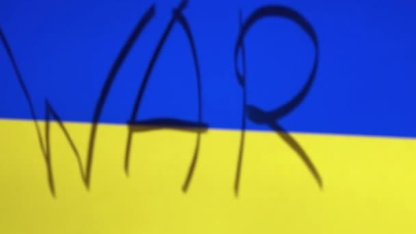 Closeup shot of the Ukrainian flag with WAR written on it. Russian invasion — Stock Video