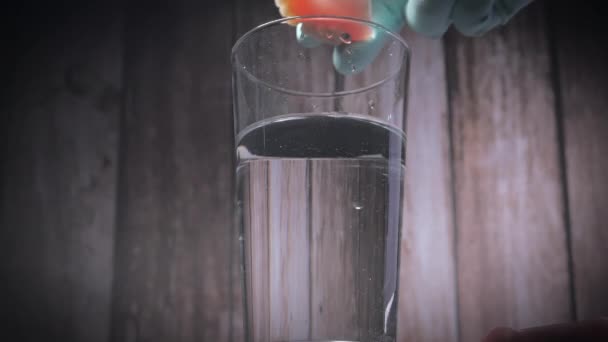 Close-up shot van het plaatsen van prothese tanden in een glas water. — Stockvideo