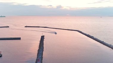 Awesome aerial shot of a motorboat sailing into the Pirita marina.