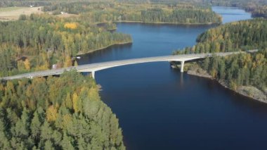 The view around the Lake Saimaa with the long bridge and the trees on the side.