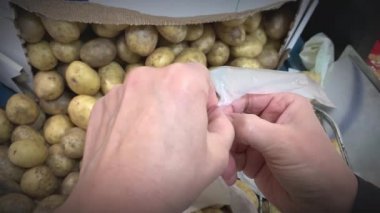 Closeup shot of opening a plastic bag in a supermarket.