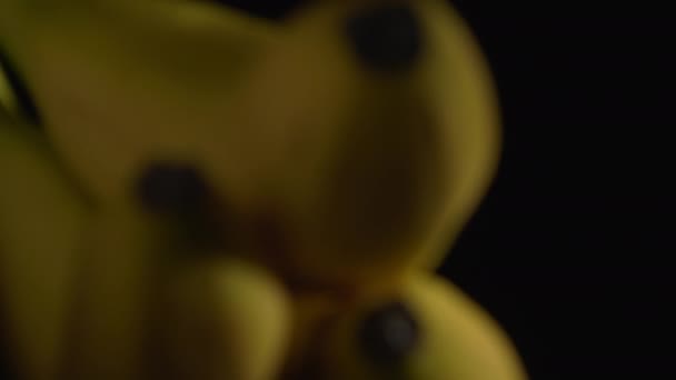 Szekrénykép szaftos banánokról egy fekete hátterű lemezjátszón. — Stock videók