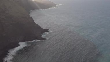 Aerial view of the big ocean in Canary Islands in Tenerife Spain with the big mountain cliff on the side.geology shot.4k