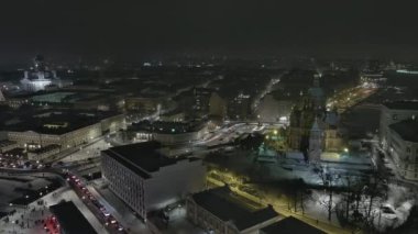 Helsinki.Finland-December 31.2021: Aerial shot of the cityscape of Helsinki during fireworks. Nighttime. Wintertime. New years eve. Drone slowly turning left.