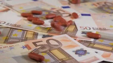 Kahverengi hapların yakın plan çekimi 50 Euro 'luk banknotların üzerine bırakılıyor. İnsanların pahalı sağlık hizmetleri ve tıp konsepti için yeterli parası yok. Stüdyo çekimi. 