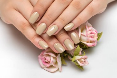 Kırmızı ve pembe güllerle bej renginde narin manikür.