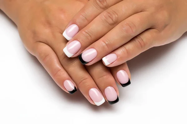 French white, black manicure on short square nails close-up on a white background