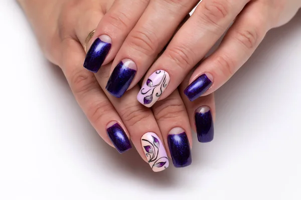 Gel manicure with flowers. Blue shiny, purple shiny moon manicure on long square nails close-up on a white background. Abstraction.