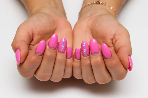 pink moon manicure on long oval nails with triangles, crystals on a white background