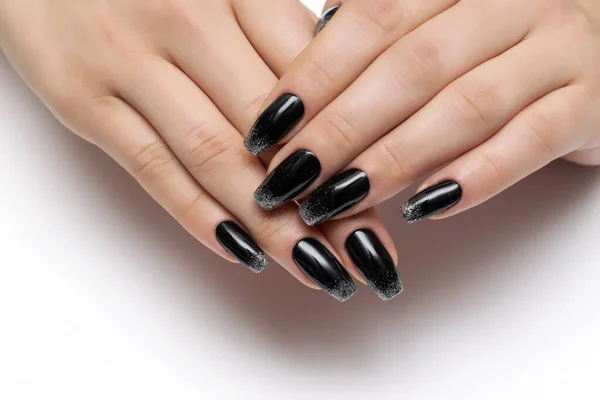 Black manicure with silver sequins on a free nail on long nails. Ballero nail shape. Close-up on a white background.