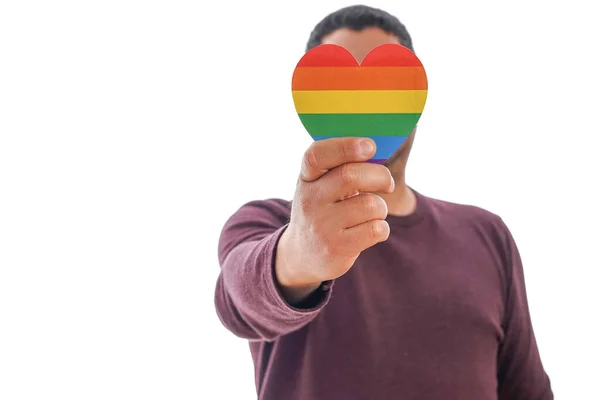 Unrecognizable mature man holds a heart with the colors of the LGBTQ movement on white background. Concept of tolerance, inclusion and diversity. — Stockfoto